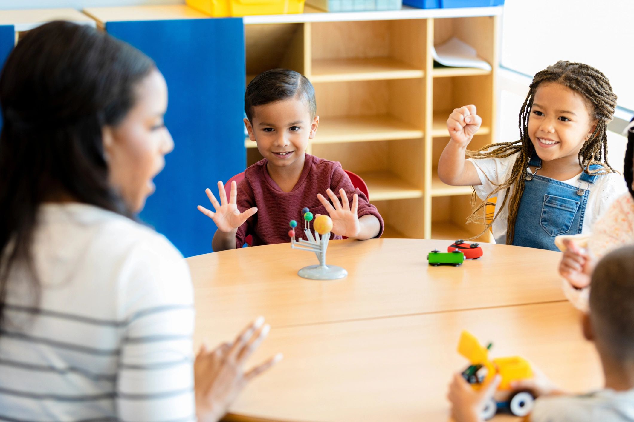 Preschool teacher working with children during a learning activity