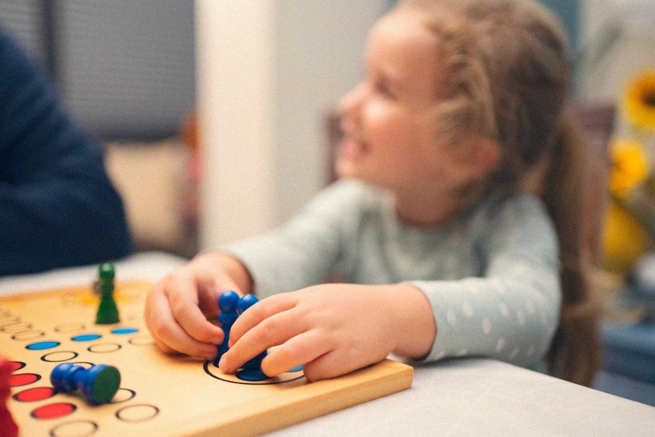 Grandparent and child playing a board game to practice skills